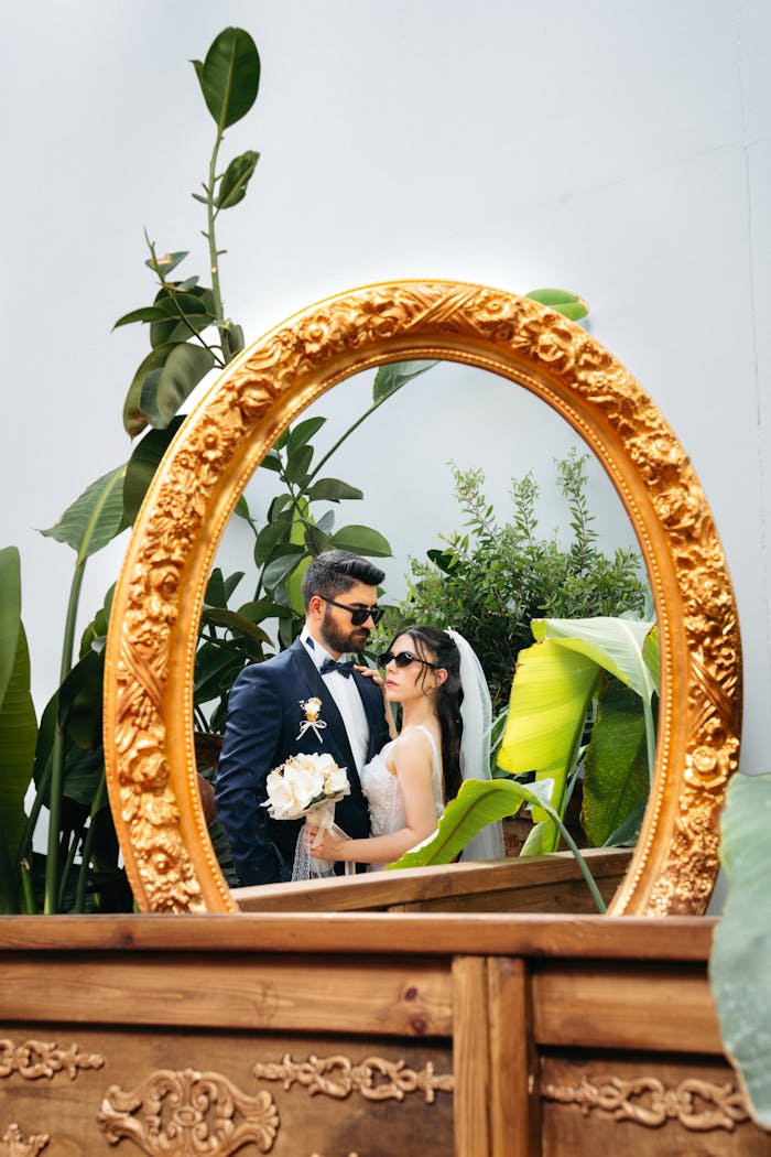 Reflection of a stylish couple embracing on their wedding day in Antalya.