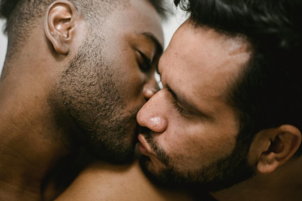 pexels photo 4830972 4830972 Close-up of an interracial gay couple sharing an intimate kiss, expressing love and togetherness.
