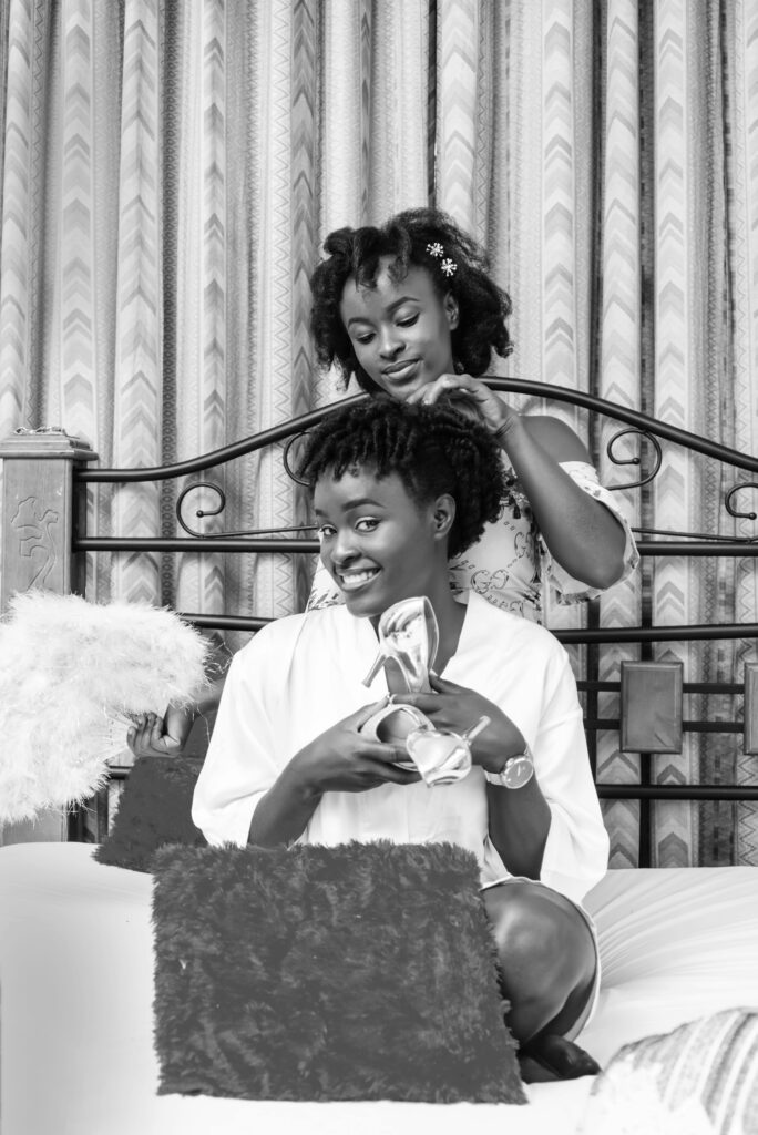 pexels photo 4843975 4843975 Two women enjoying a joyful moment getting ready for a wedding in a cozy room.