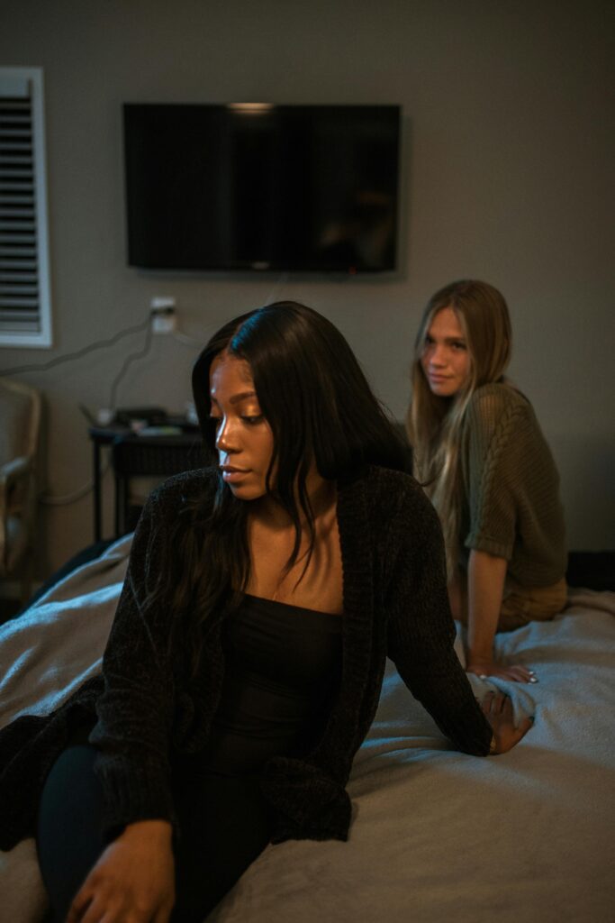 pexels photo 5617838 5617838 Two women in a bedroom having a deep, emotional conversation. Tension is visible.