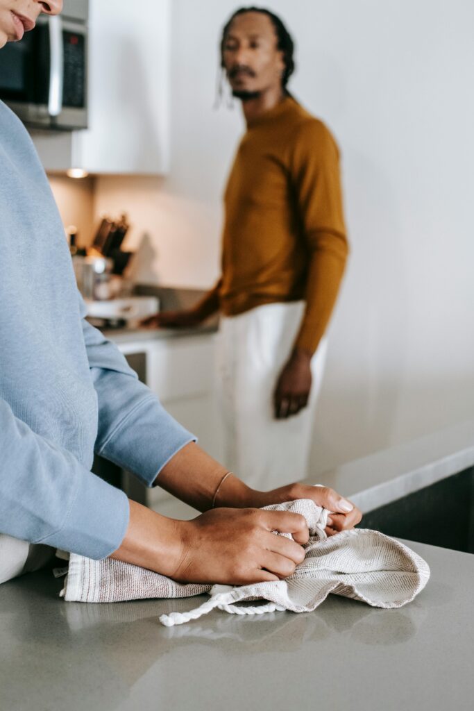 pexels photo 5699714 5699714 African American couple having conflict while standing in kitchen in daylight and wearing casual outfit